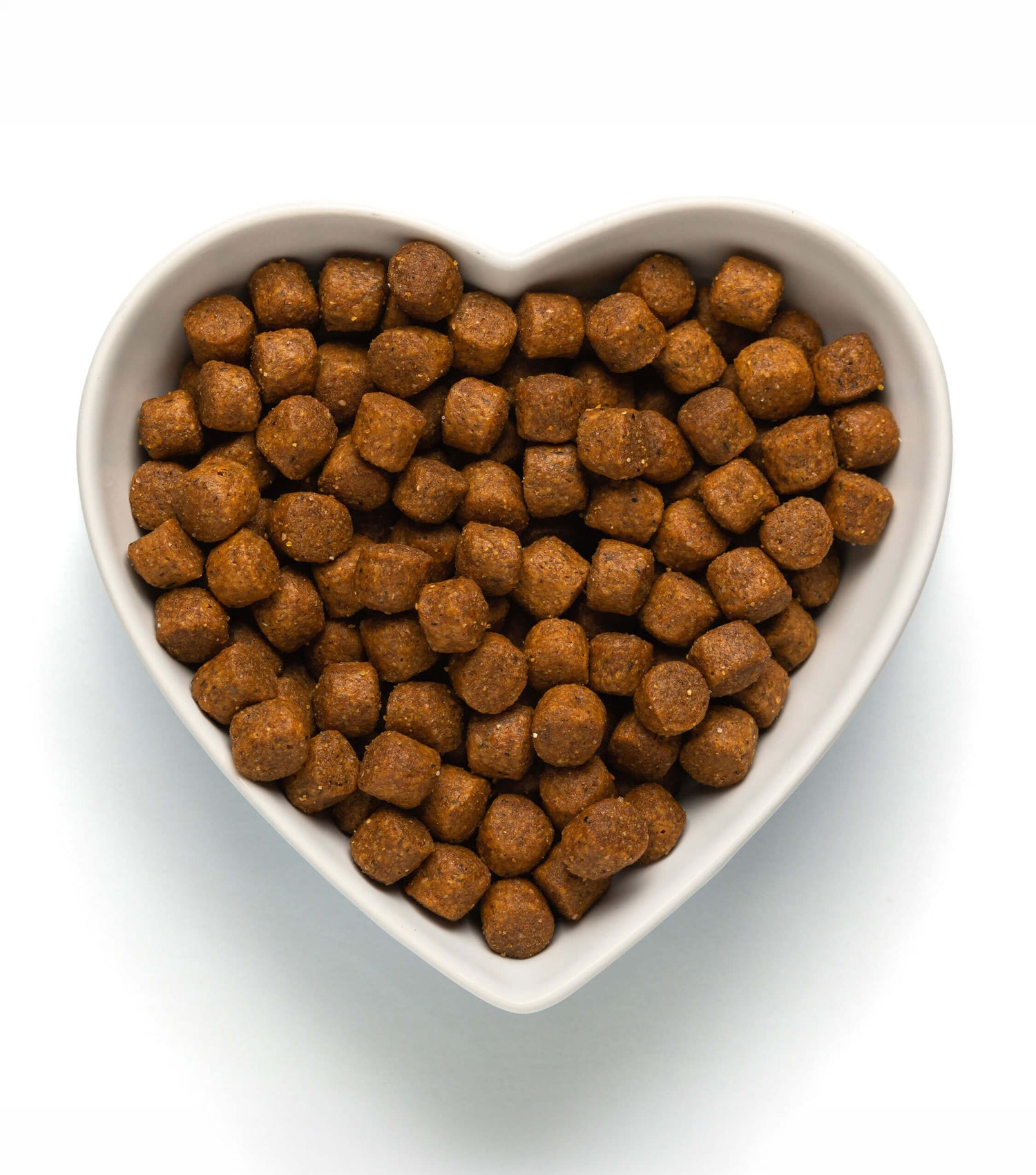 Heart-shaped bowl of Husse kibble made without artificial colours, flavours or fillers