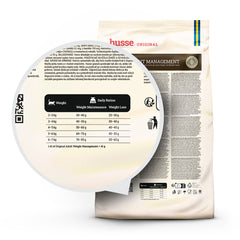 Feeding guide and daily ration table on a husse Adult Weight Management dry cat food bag.