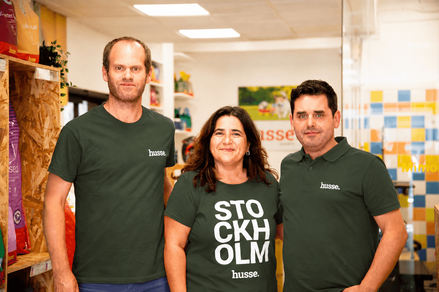 Three Husse Portugal team members in branded polo shirts at the Husse depot