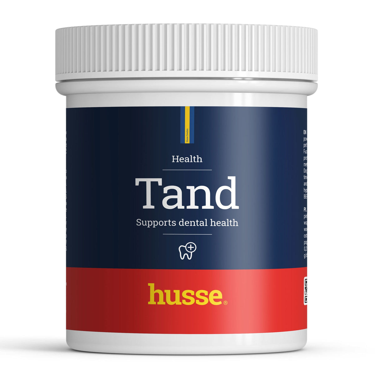 Pó para cuidados dentários Husse Tand num frasco branco com tampa canelada e rótulo azul-escuro e vermelho.